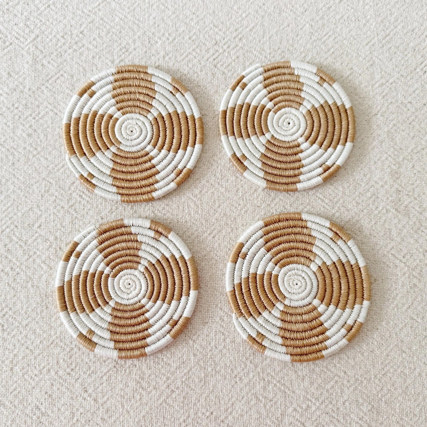 Mahjong Table Protection Coaster Set Handwoven Sisal Natural Fiber Circle Design Artisan Crafted Rwanda Female Weavers Tan White Spiral Pattern Four Inch Diameter Game Night Essential Beverage Protection Surface Care Handmade Quality Set Of